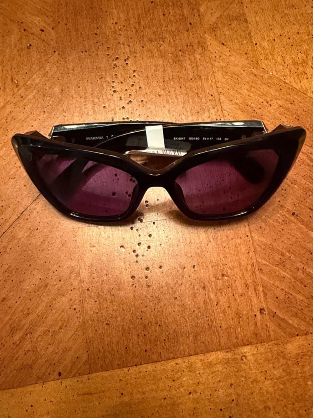 Swarovski Women's Black Frame Sunglasses with Purple Lenses - Cat Eye Style